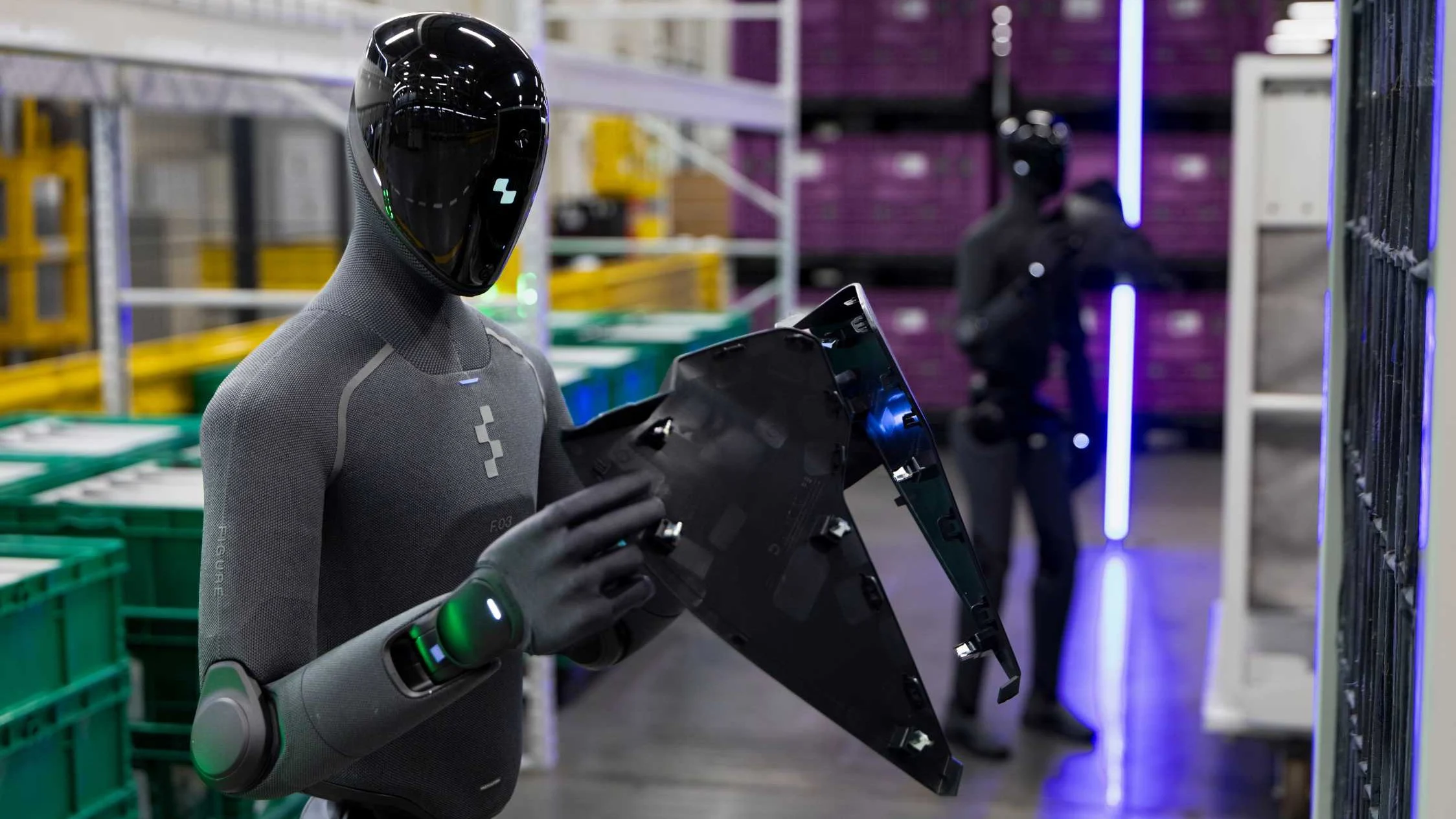 Figure 03 humanoid robot handles a vehicle component in a BMW Group logistics hall