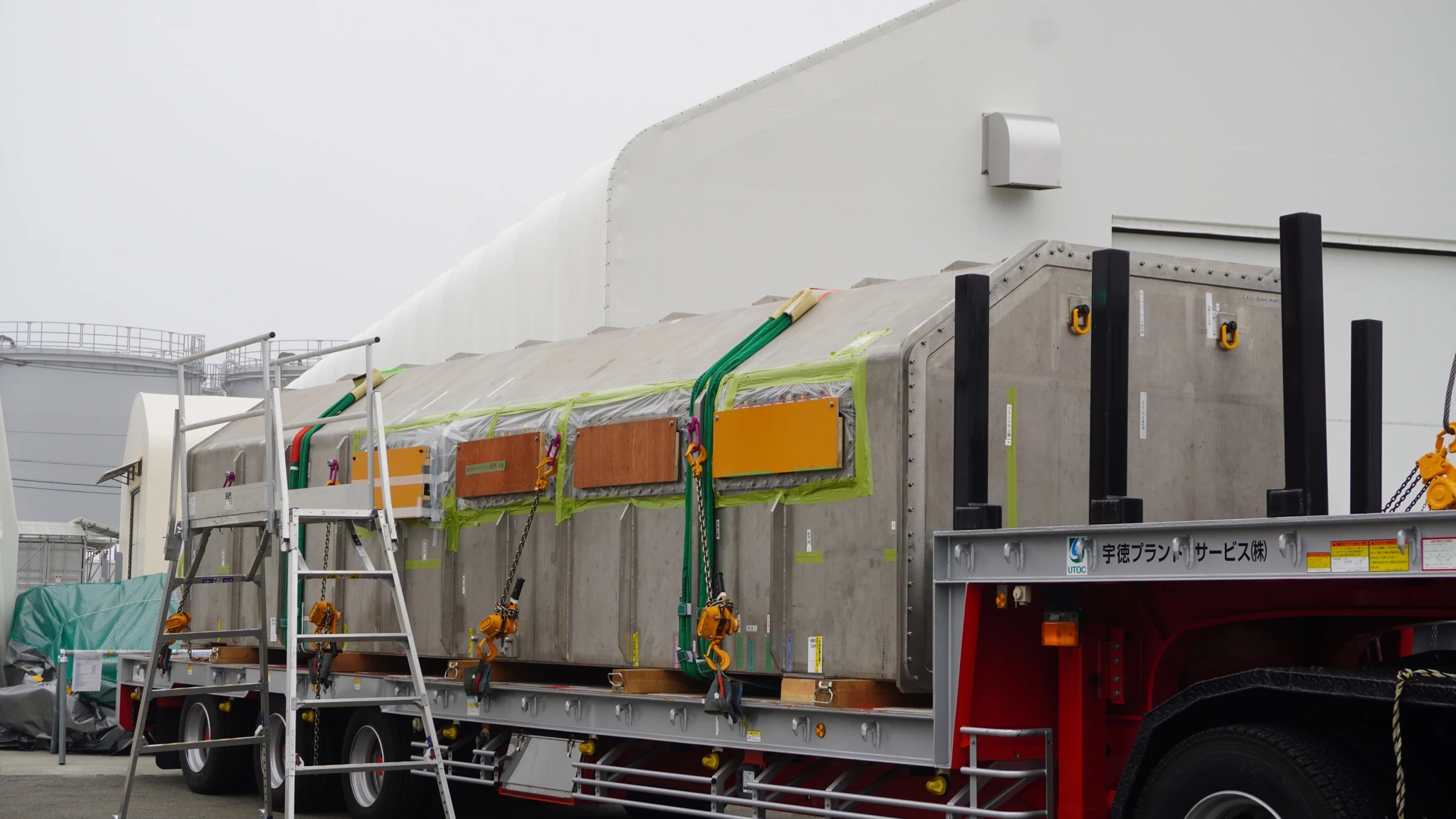 TEPCO’s enclosed Unit 2 robot arm arrives on a trailer at Fukushima Daiichi in April 2026