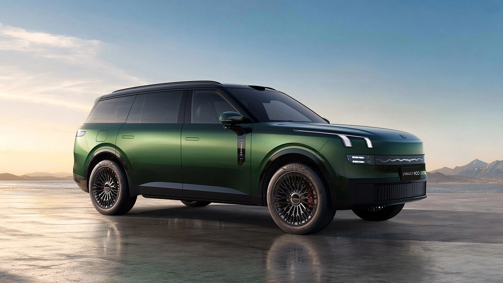 Green Lynk & Co 900 SUV shown in a three-quarter front view beside a shoreline