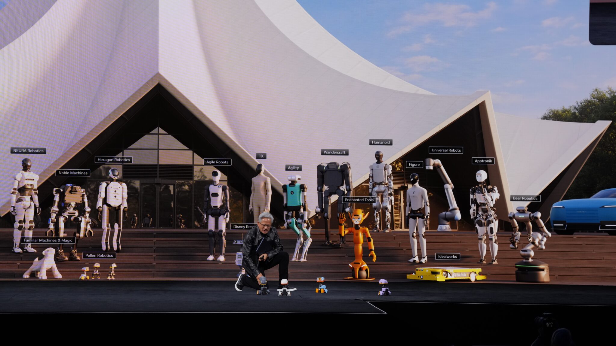 Jensen Huang crouches beside four Microduck robots onstage during his NVIDIA GTC Berlin keynote on 21 October 2026.