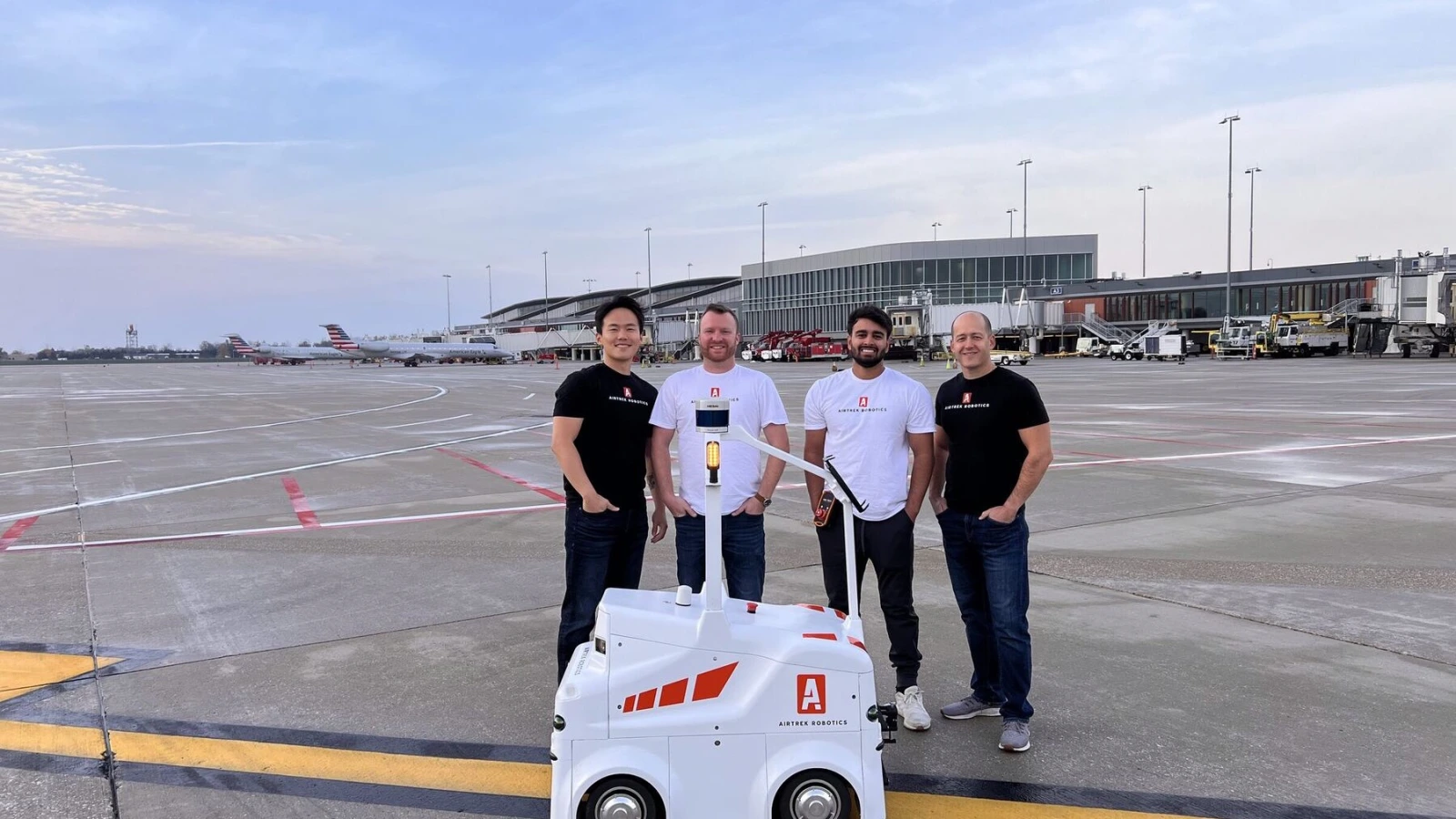 Airtrek Groundwatch robot with company team on an airport apron in an official Airtrek photograph