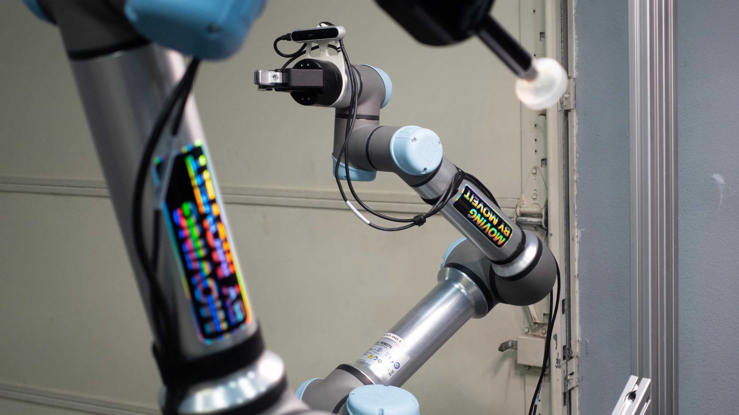 Robot arms with MoveIt stickers, a gripper and a camera in an archive photograph supplied through PickNik’s press kit.