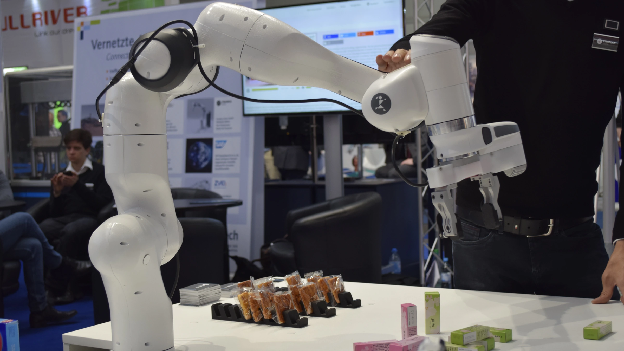 Archive photograph of a white Franka Emika robot arm above a demonstration table at CeBIT 2017.